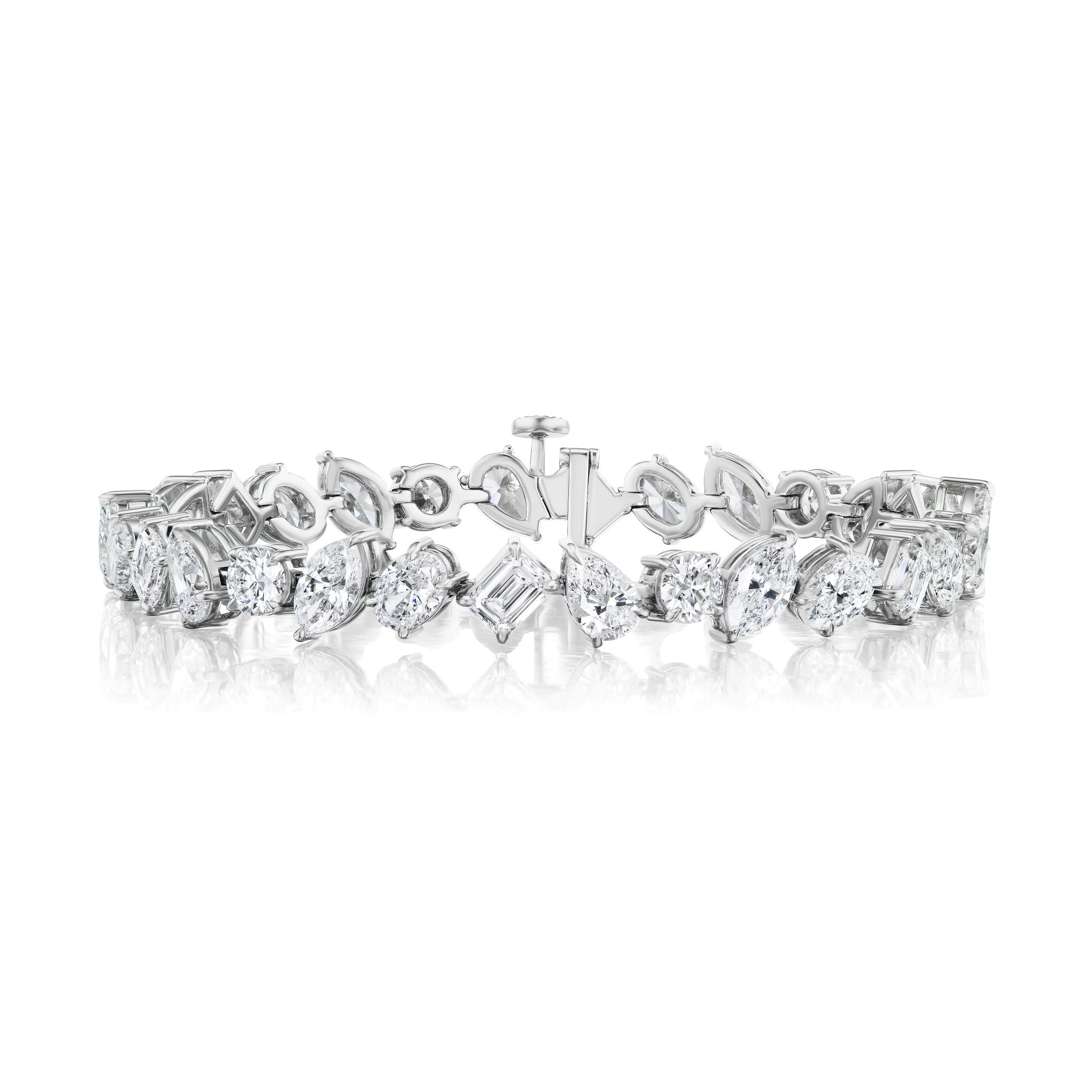 The Mixed Shape Diamond Tennis Bracelet in white gold features alternating marquise and emerald-cut diamonds, arranged in a repeating pattern and displayed on a white background with a subtle reflection below.