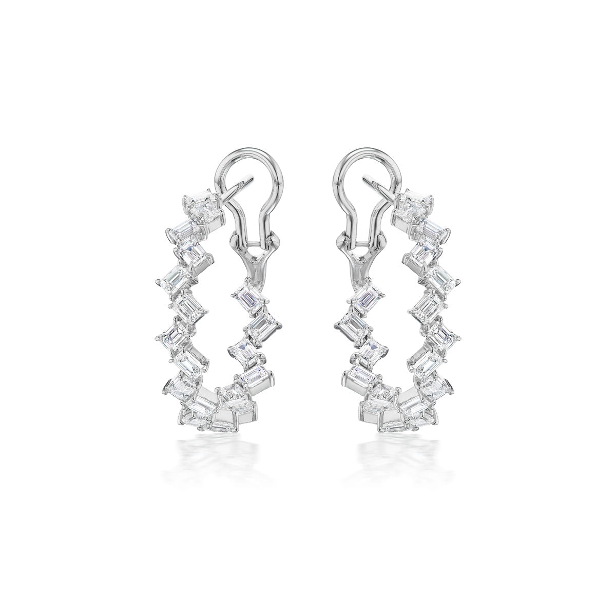 The Zigzag Emerald Cut Diamond Hoops are 18K white gold earrings featuring clear, emerald-cut diamonds arranged around the hoops and secured with a top clasp, shown on a white background.