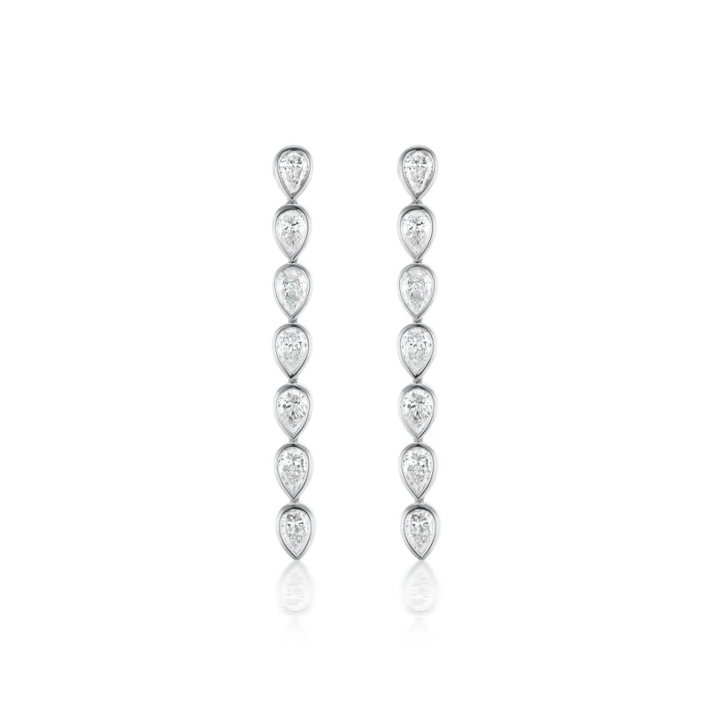 The Chasing Pears Drop Earrings in white gold feature five bezel set pear diamonds arranged vertically in a sleek, elegant line.