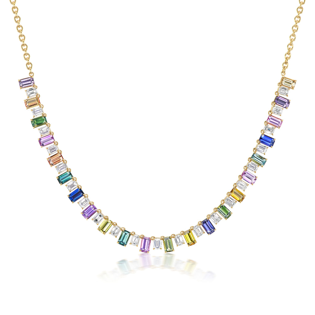The Confetti Necklace in Yellow Gold features a front-spanning row of emerald cut, multicolor sapphires in a gradient pattern, all set in 18K yellow gold.