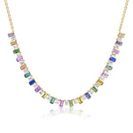 The Confetti Necklace in Yellow Gold features a front-spanning row of emerald cut, multicolor sapphires in a gradient pattern, all set in 18K yellow gold.