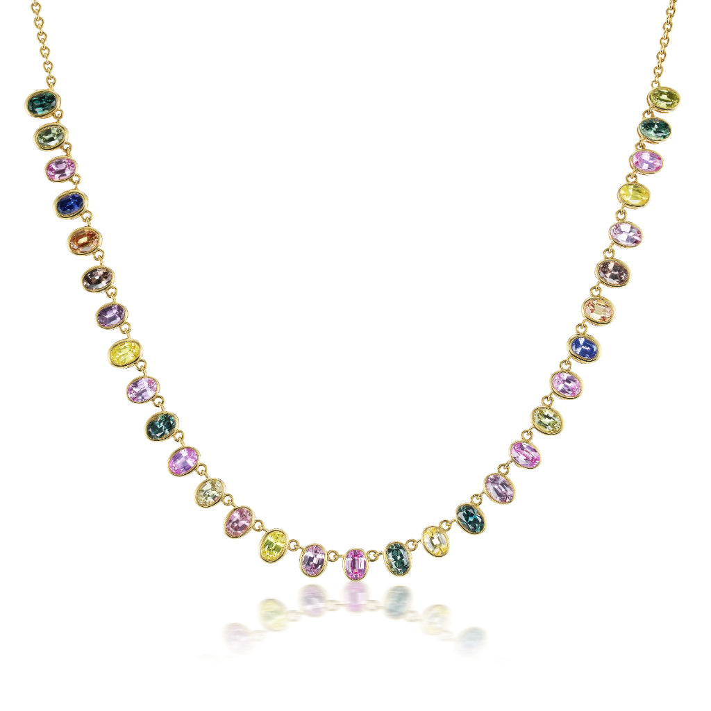 The Gumdrop Necklace in yellow gold showcases oval multicolor sapphires bezel set along the chain, offering vibrant elegance.