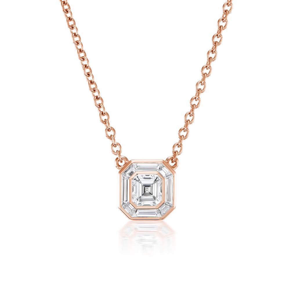 The Emerald Cut Diamond Mosaic Pendant in Rose Gold features an 18k rose gold chain with an Art Deco pendant showcasing a central emerald-cut diamond surrounded by baguette diamonds.