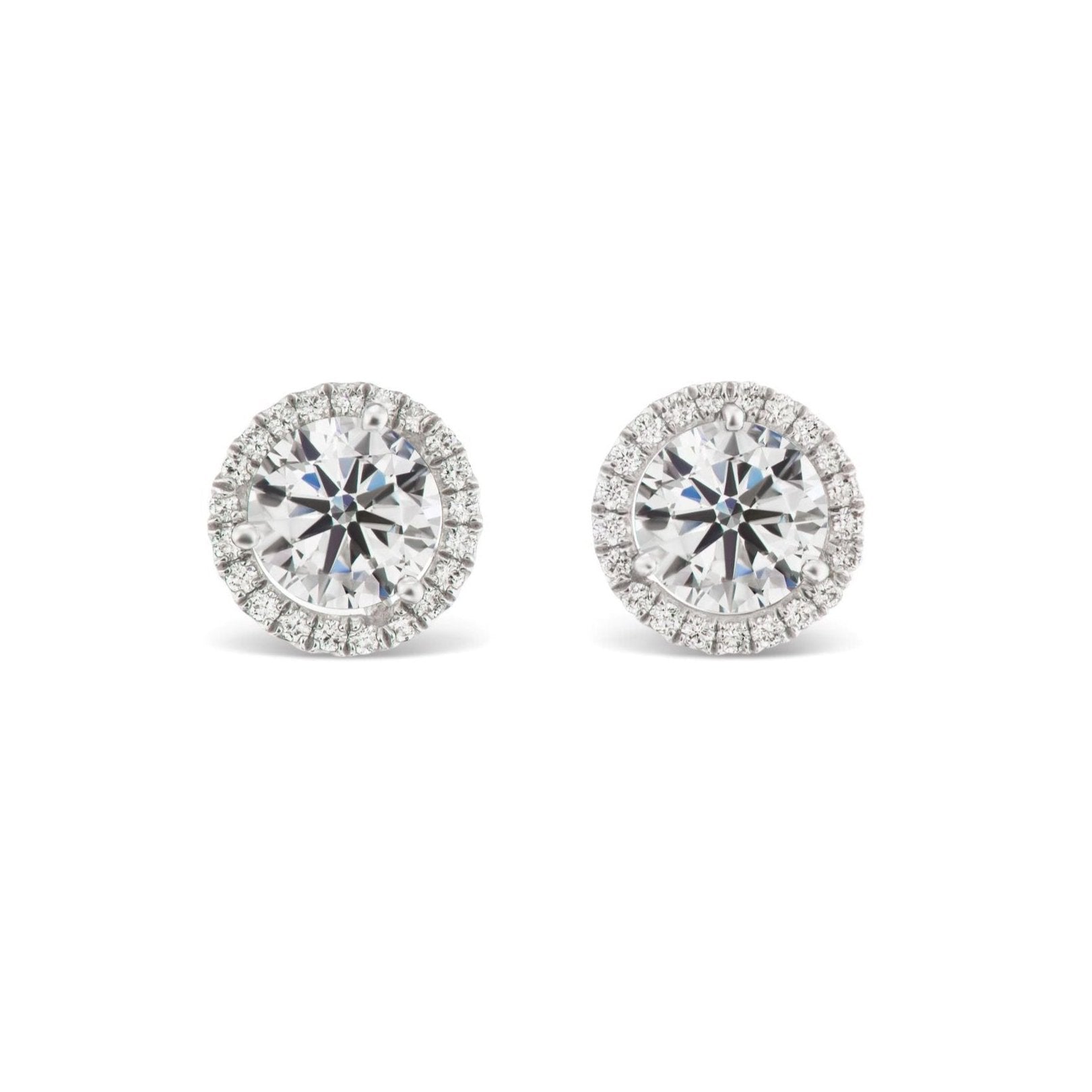 Pavé Halo Ear Jackets in Platinum with round brilliant diamonds, each earring featuring a central diamond surrounded by a pavé-set halo for added shimmer.