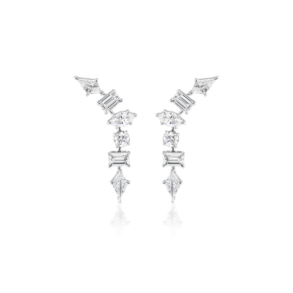 The Mixed Shape Waterfall Earrings are asymmetric silver earrings with kite diamond and geometric-cut clear VS+ gemstones arranged in a zigzag on a white background.