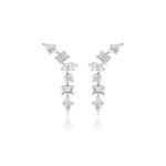 The Mixed Shape Waterfall Earrings are asymmetric silver earrings with kite diamond and geometric-cut clear VS+ gemstones arranged in a zigzag on a white background.