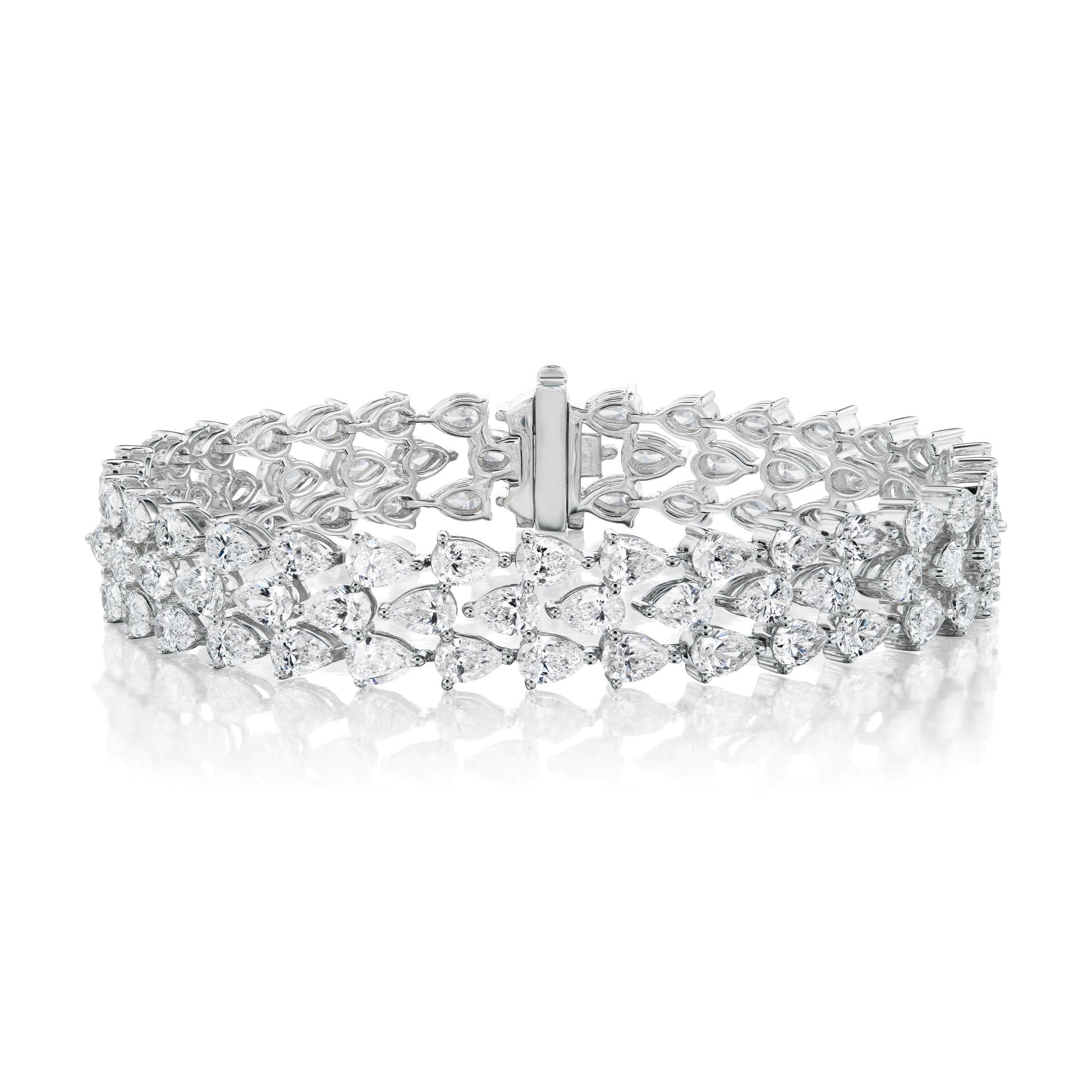 The Chasing Pears Triple Row Bracelet, crafted in 18K white gold, features three rows of sparkling gemstones set in a symmetrical design with a secure clasp. It is showcased against a white background.