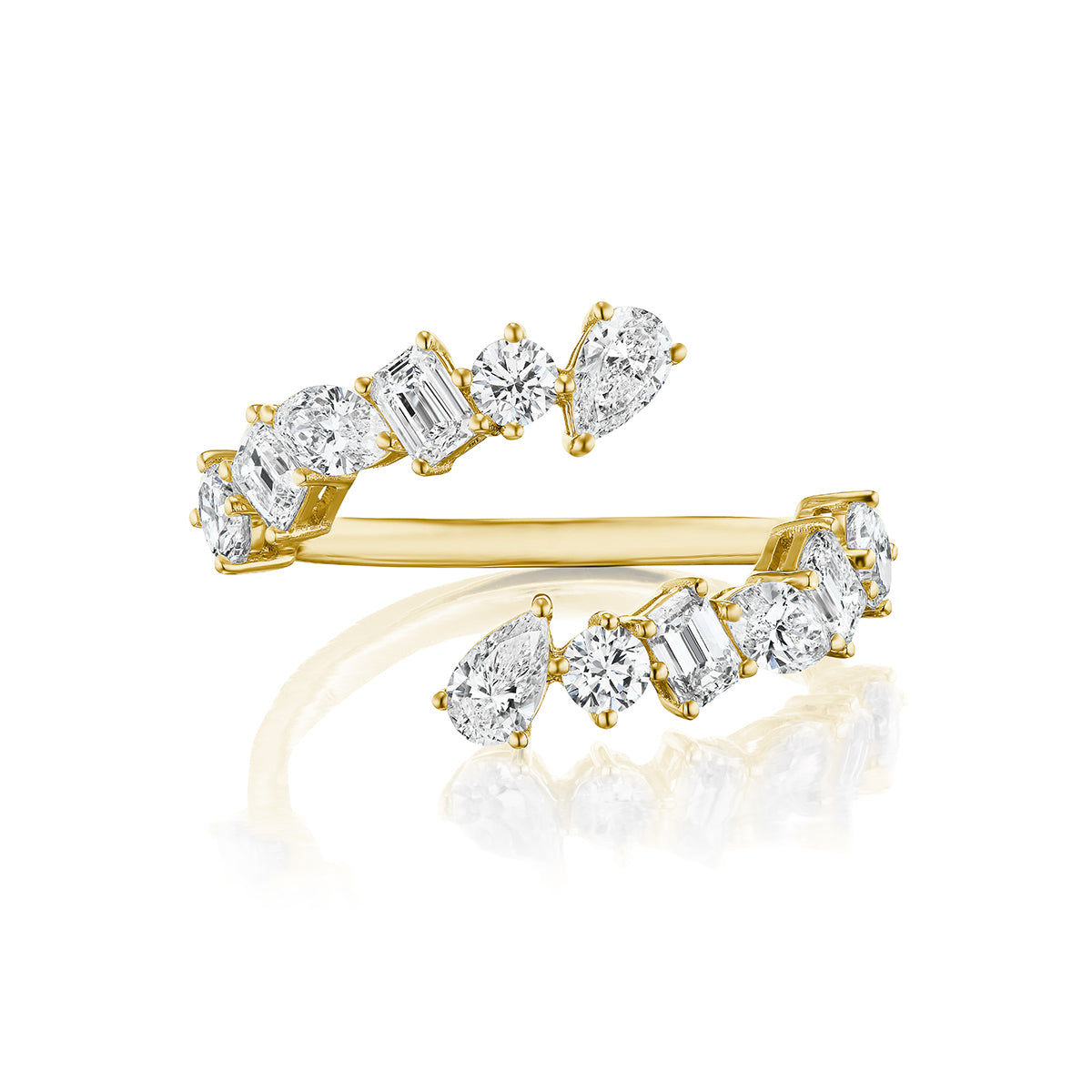 The Wraparound Ring with Mixed Shape Diamonds features an 18K gold band adorned with round, emerald, oval, and pear-shaped diamonds arranged in an asymmetrical bypass design.