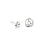 The Pavé Halo Ear Jackets in Platinum with Round Brilliant Diamonds feature one stud with a single round diamond and another with a circular platinum ear jacket adorned with pavé-set diamonds.