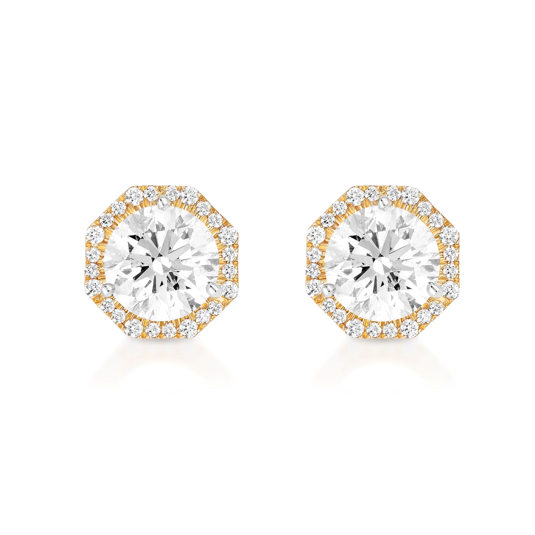 The Pavé Octagon Ear Jackets feature round brilliant diamonds in 18k gold octagonal settings, each accented with a halo of pavé-set diamonds for enhanced sparkle.