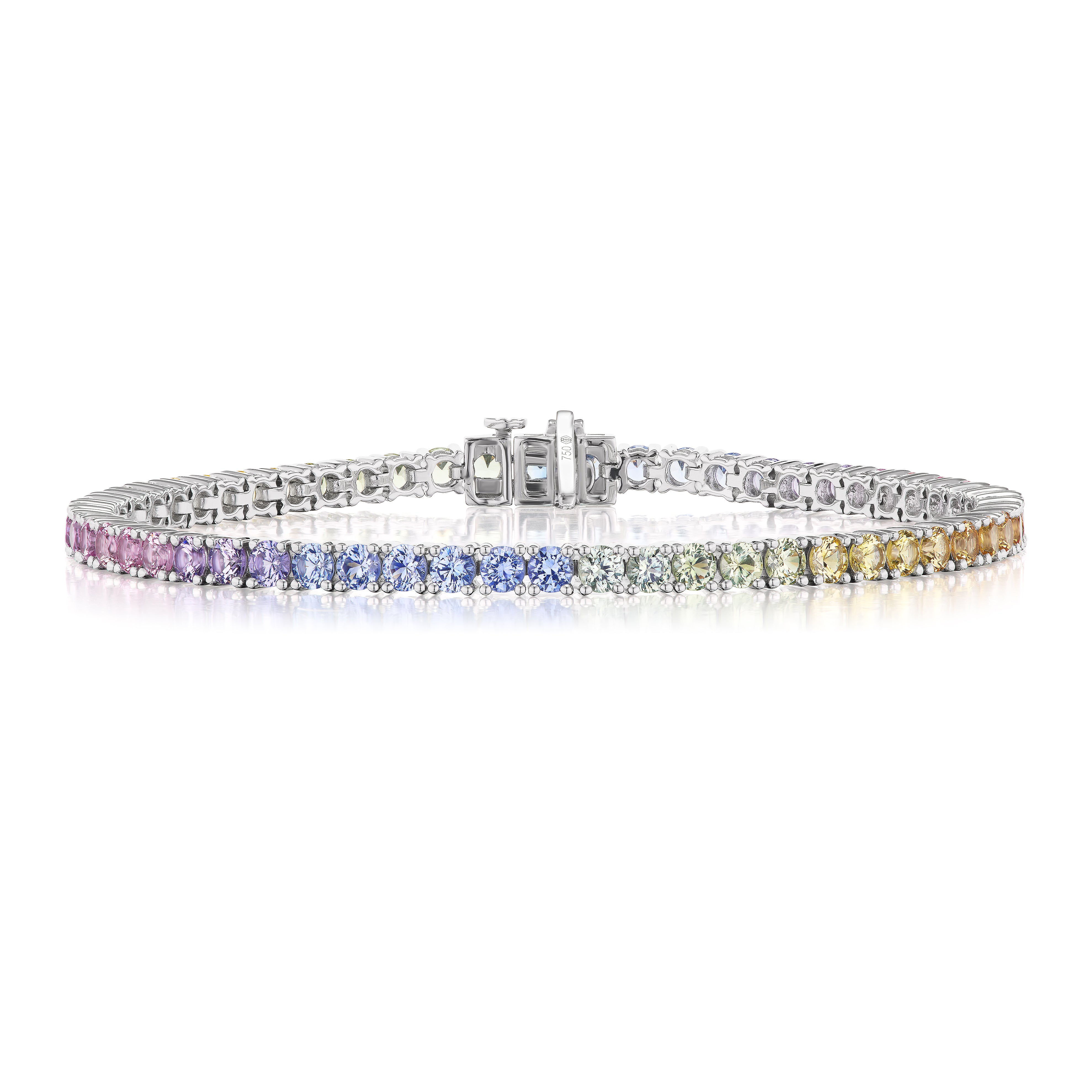 The Pastel Rainbow Tennis Bracelet showcases a row of gradient multi-colored sapphires set in an 18K white gold band and secured with a clasp.