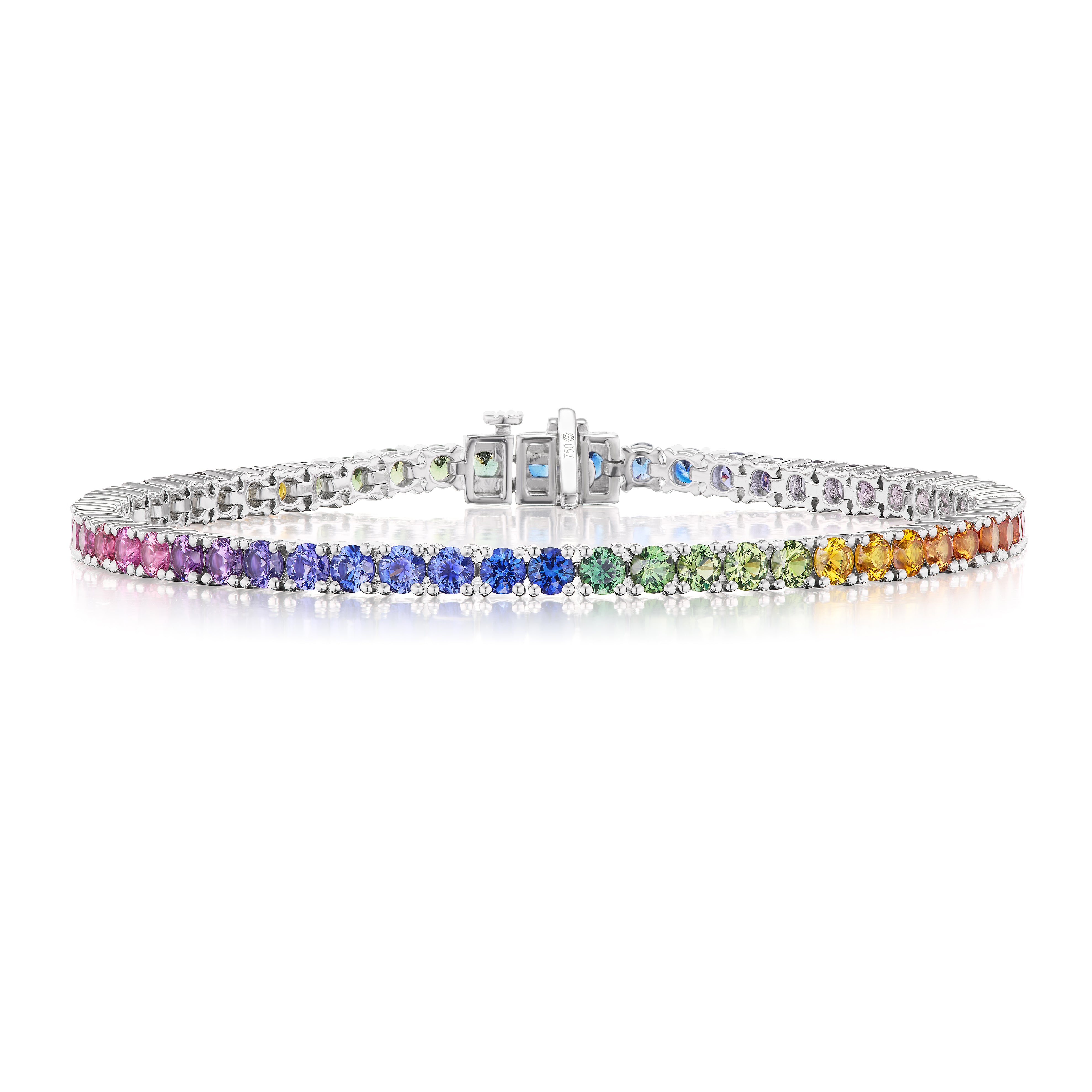 The Ombré Round Brilliant Multicolor Sapphire Tennis Bracelet displays a row of round, vibrant sapphires in an elegant rainbow gradient, set in silver and shown on a white background.