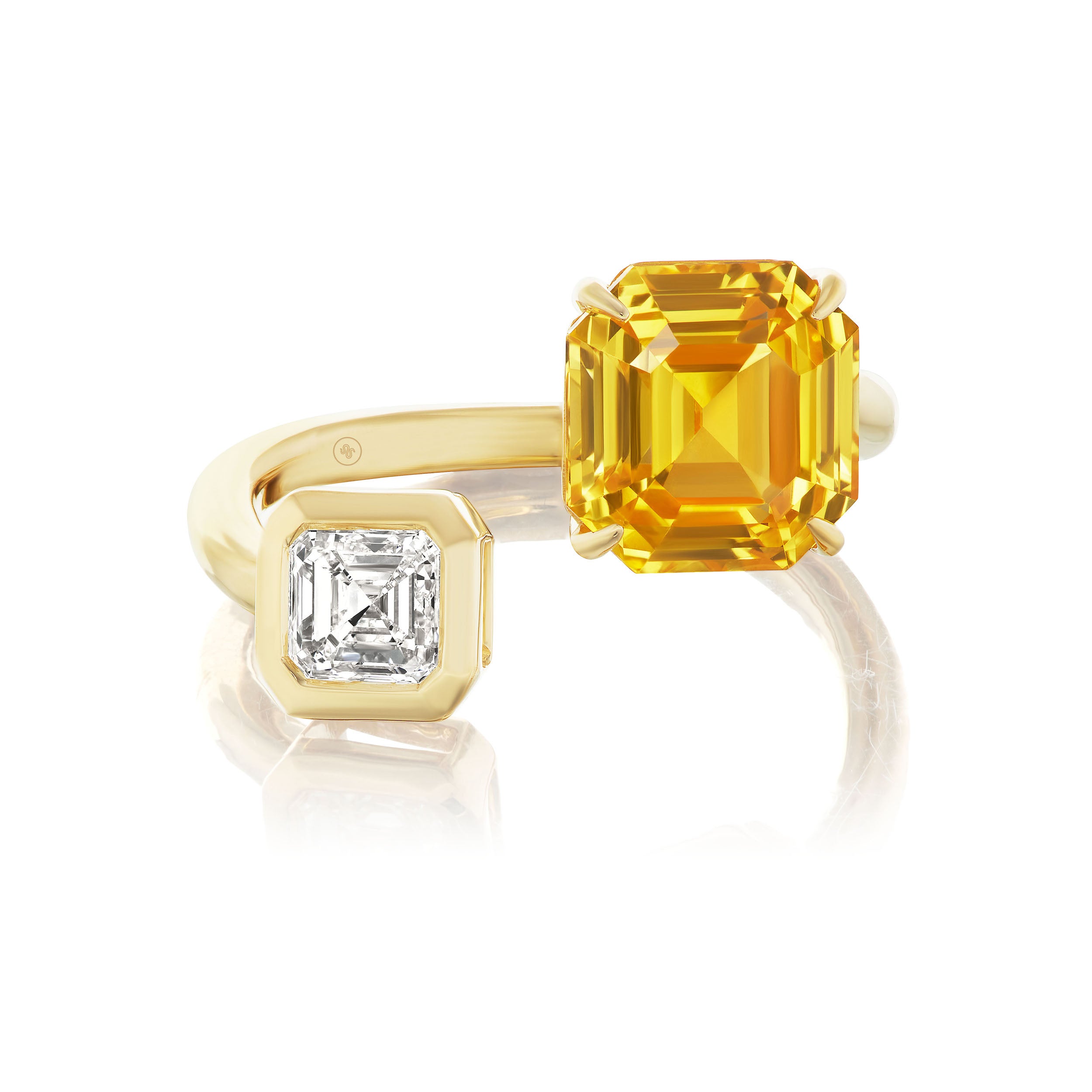 The Yellow Sapphire and Diamond Toi et Moi Ring in 18K yellow gold features an open design with a large emerald-cut yellow sapphire on one end and a smaller asscher-cut diamond set in gold on the other.