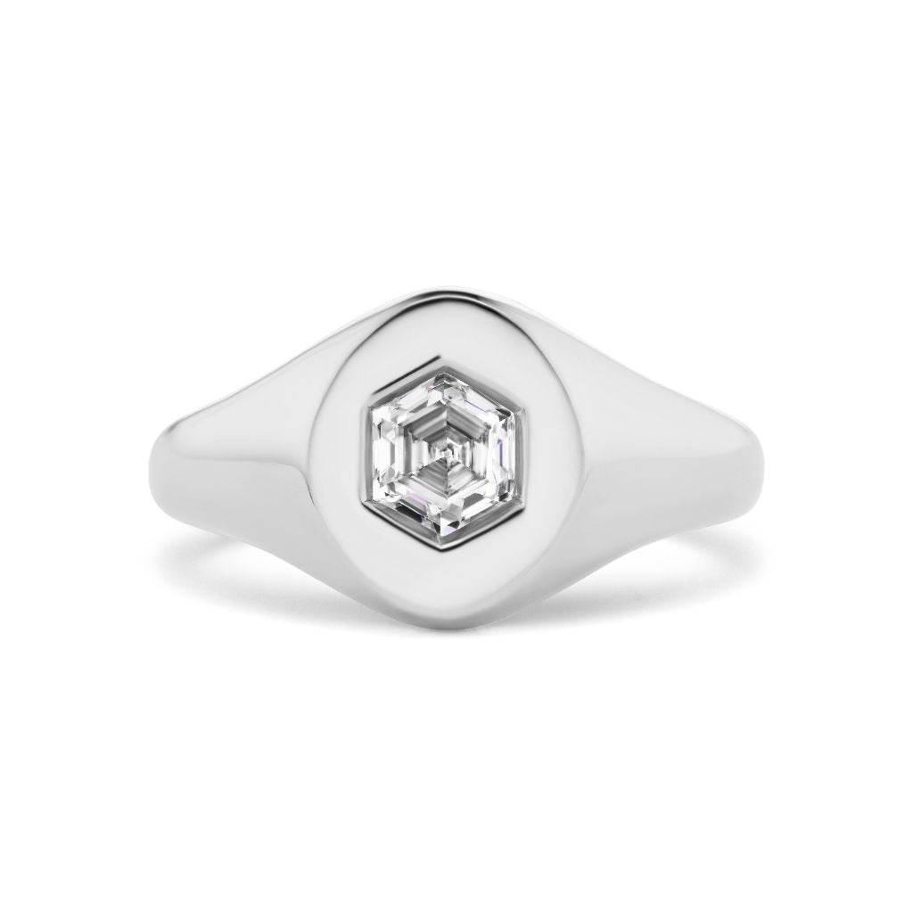 The Signet Ring with Hexagon Diamond features a smooth silver band and a central hexagon-shaped, faceted clear gemstone.